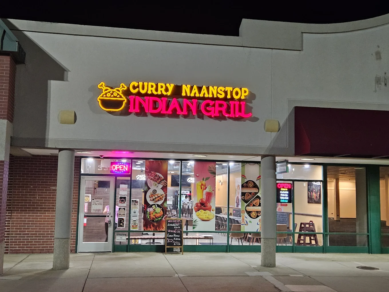 Curry NaanStop neon sign lit up at night — Arlington Heights, IL